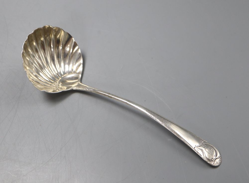 A George III base marked silver sauce ladle with scallop shell bowl, marks rubbed